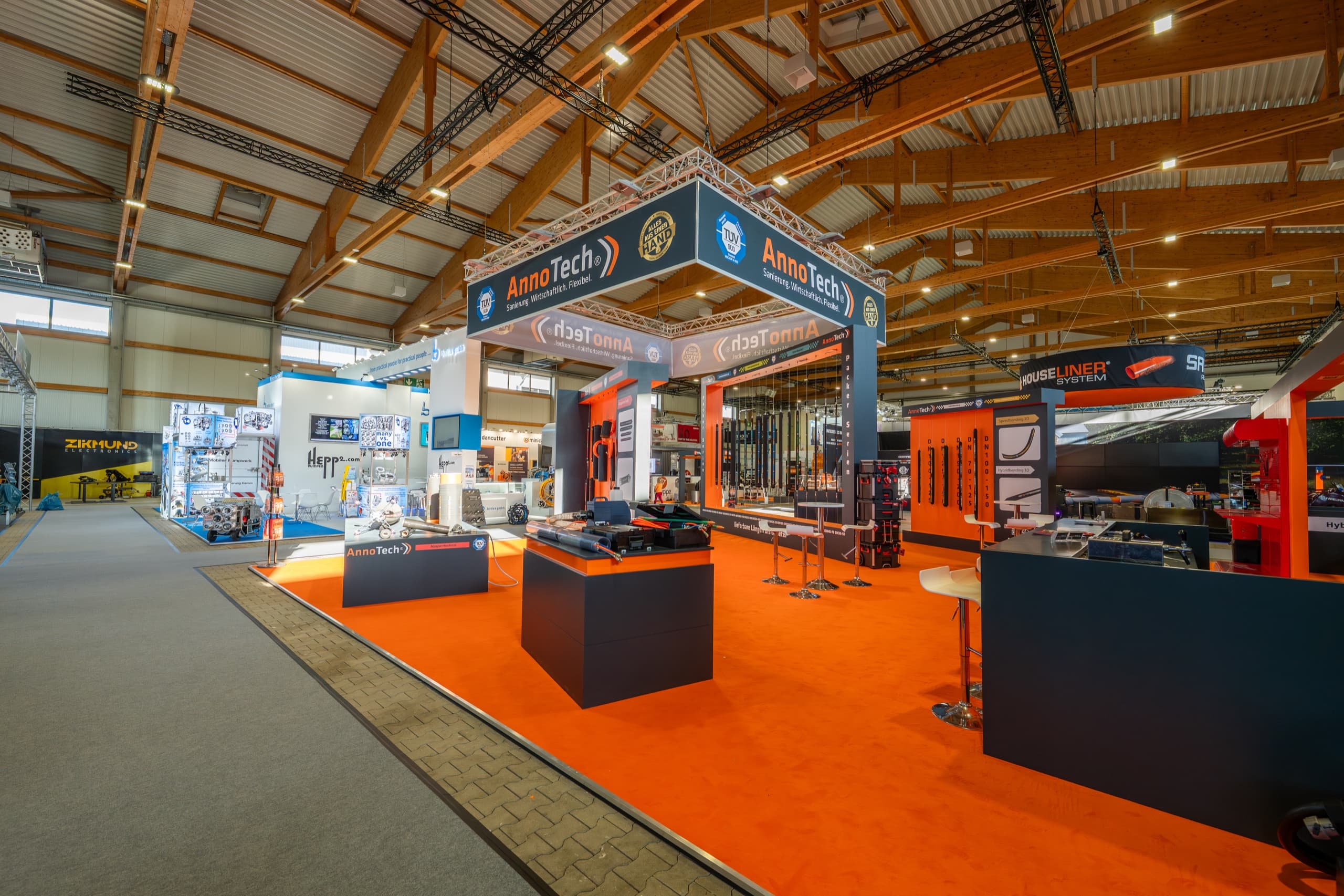 AnnoTech Messestand in voller Breite mit Packer-Produktausstellung und Messebesuchern