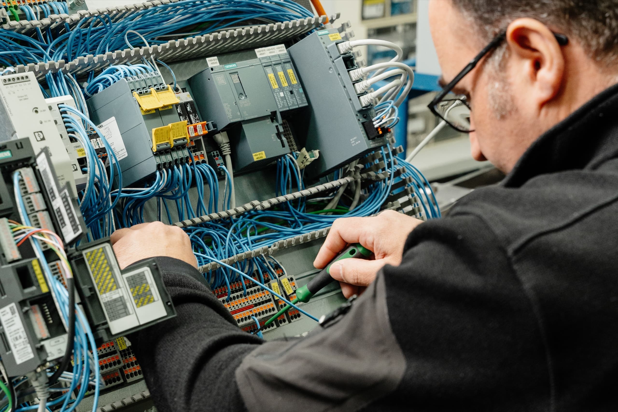 ESB Techniker verdrahtet Siemens Steuerungskomponenten in Schaltschrank
